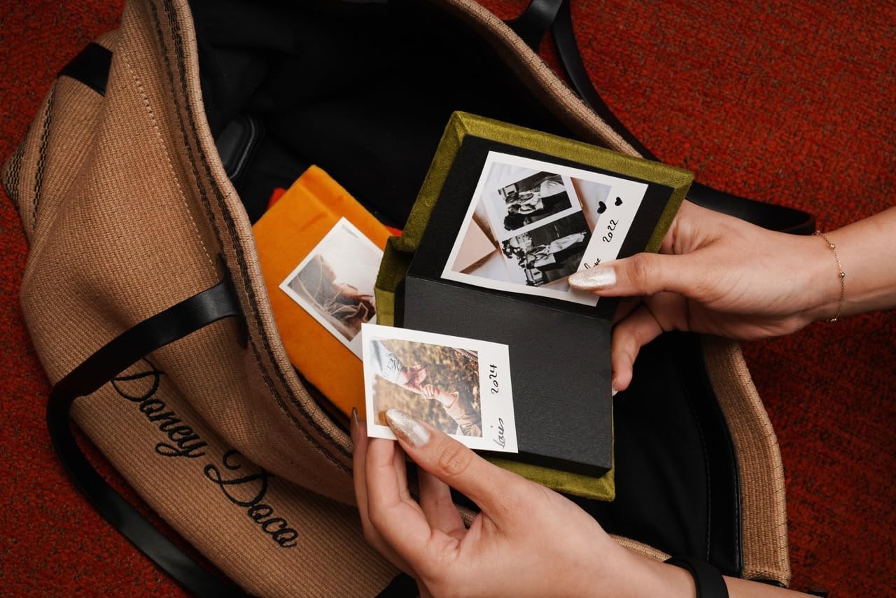 Teal blue Instax Mini album open with black tape-in pages