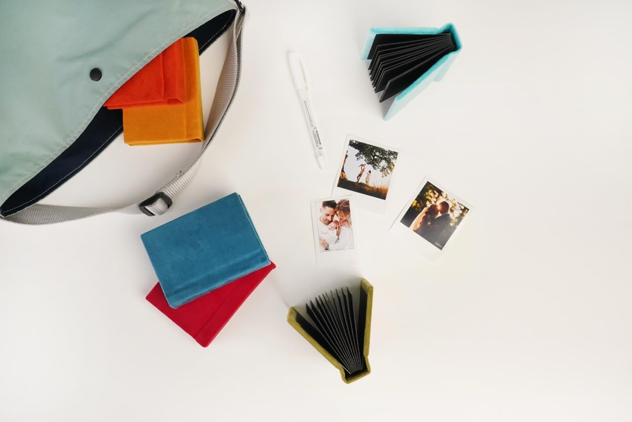 Teal Instax Mini album holding Instax Mini prints on black pages